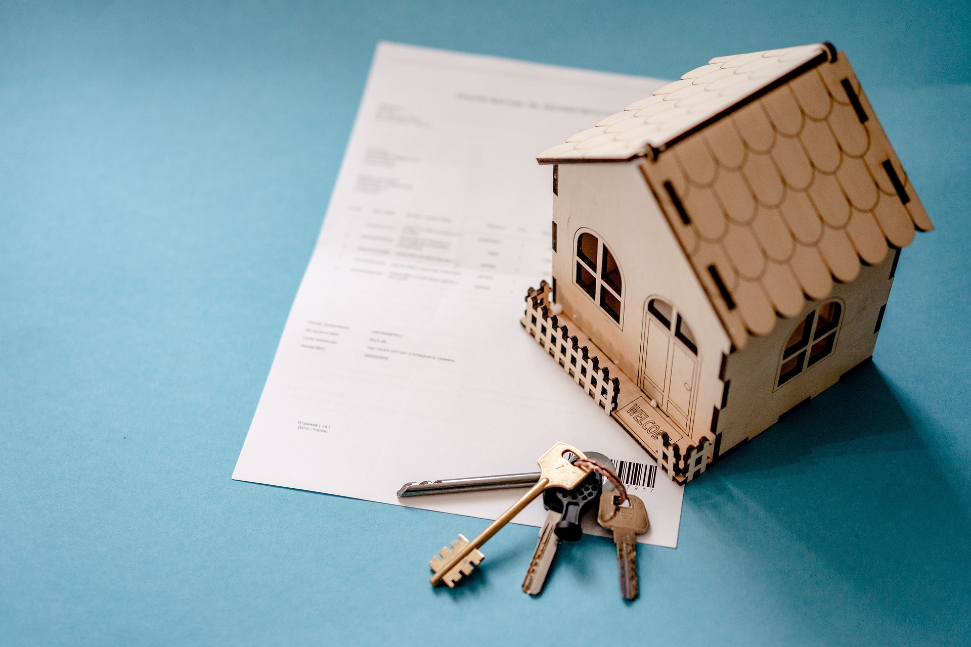 Keys and closing documents symbolizing a completed acquisition